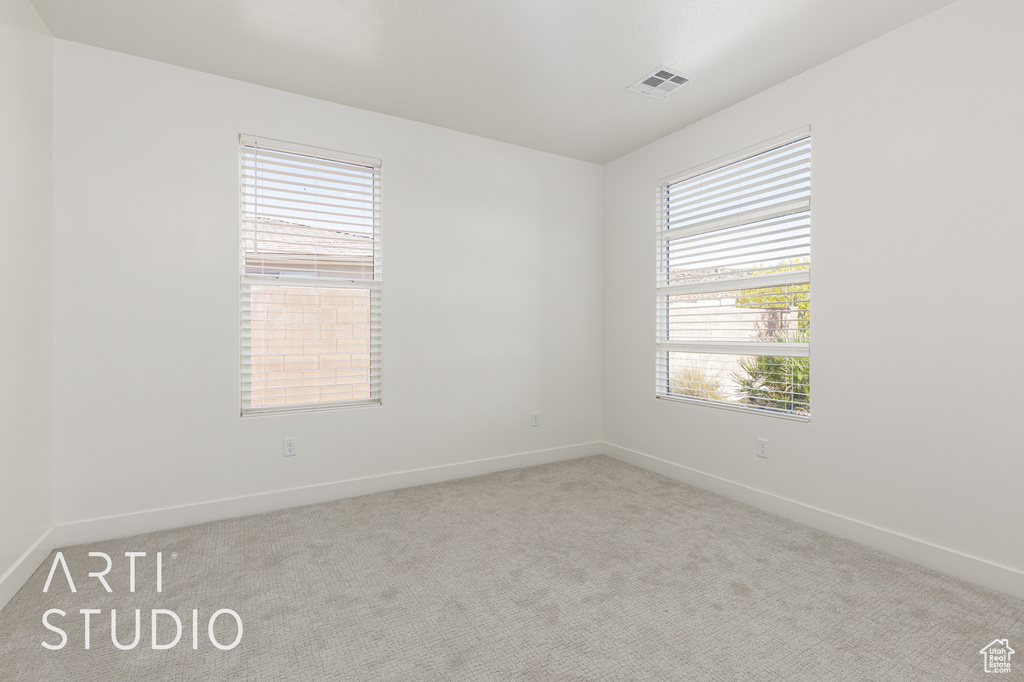 Empty room featuring carpet flooring and baseboards