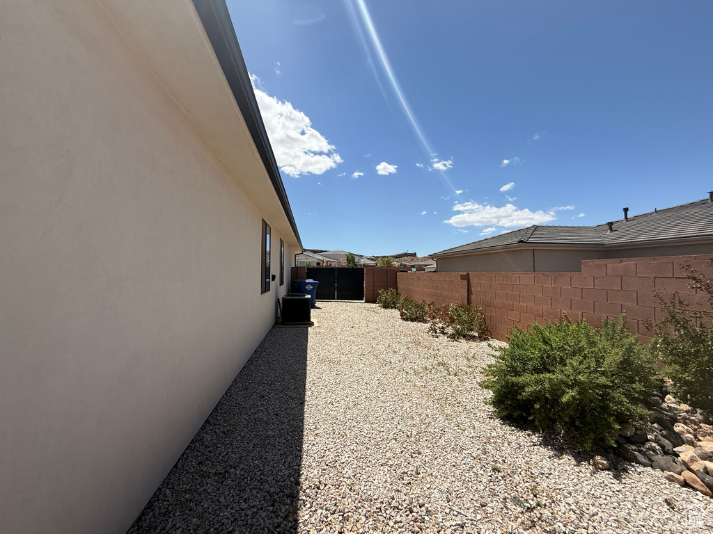View of side of property featuring fence and stucco siding