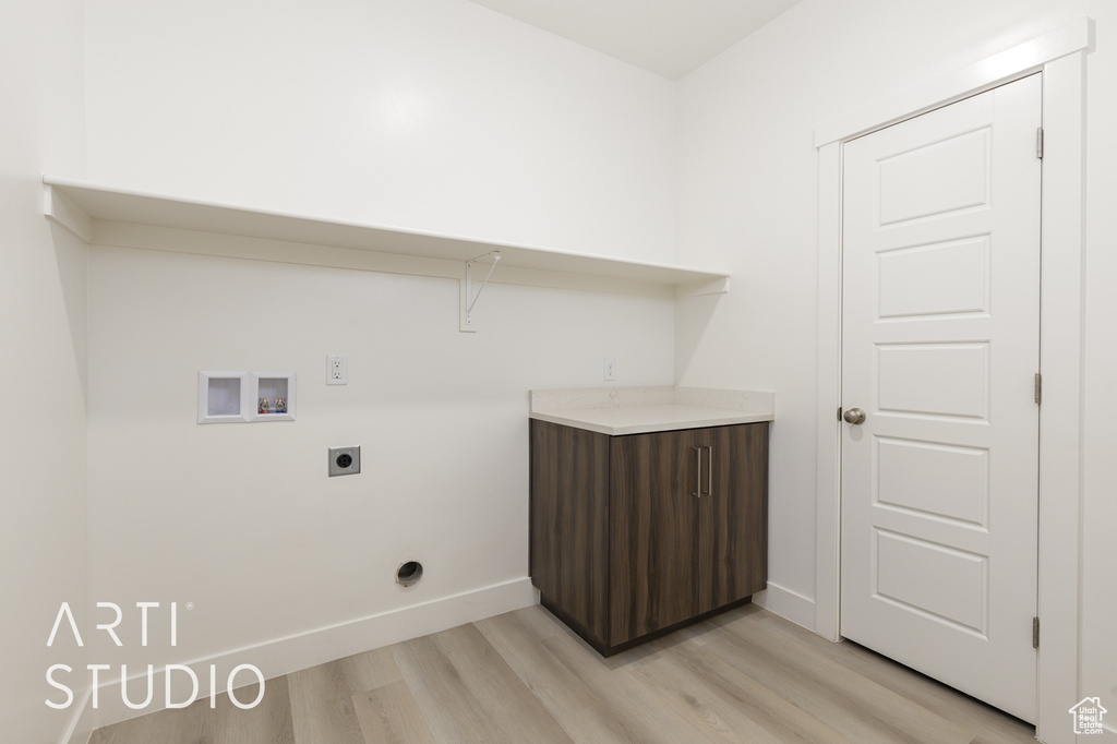 Laundry room featuring hookup for an electric dryer, light wood-type flooring, washer hookup, and baseboards