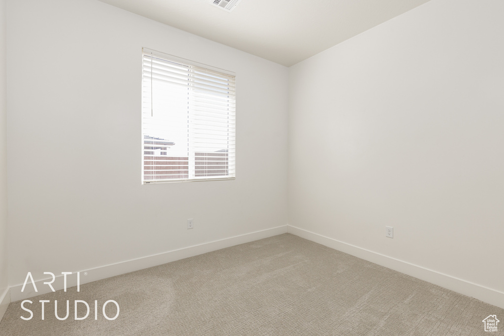 Empty room featuring carpet floors and baseboards
