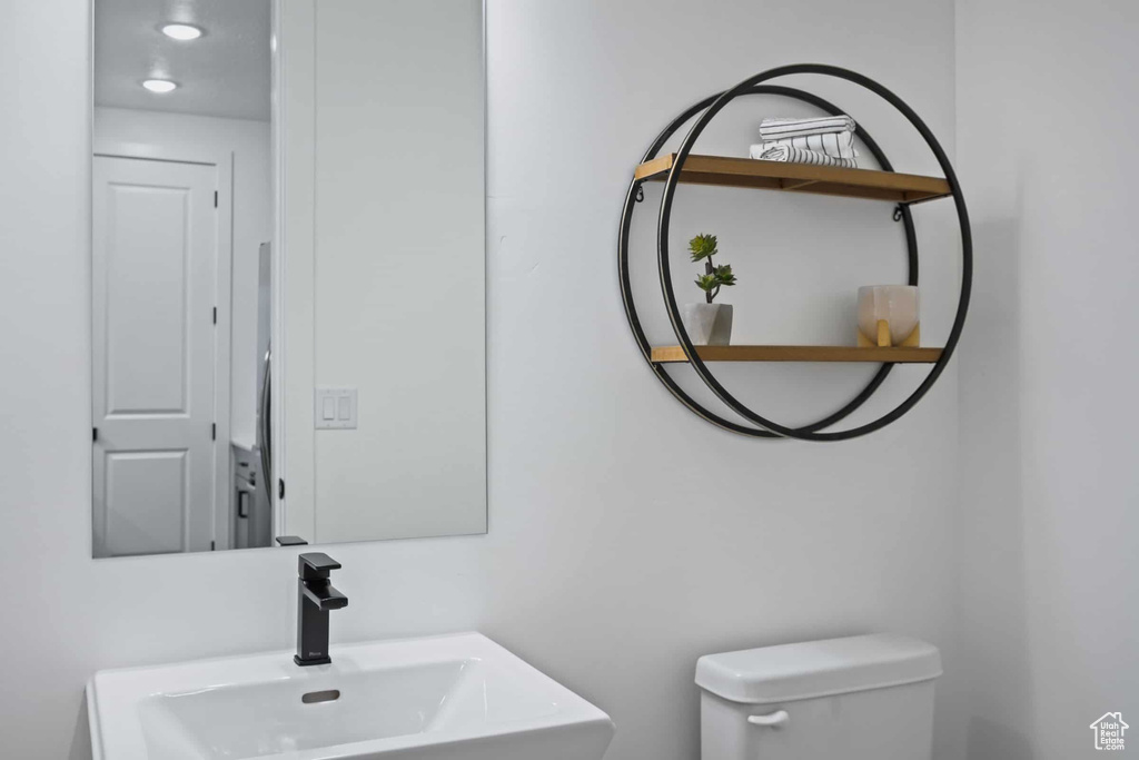 Half bath with a sink and toilet