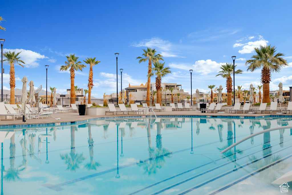Community pool featuring fence and a patio