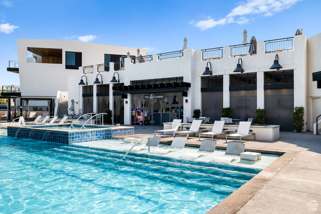View of pool featuring a pool with connected hot tub