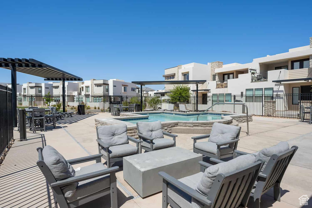 Community pool with a residential view, fence, a patio, and an outdoor living space