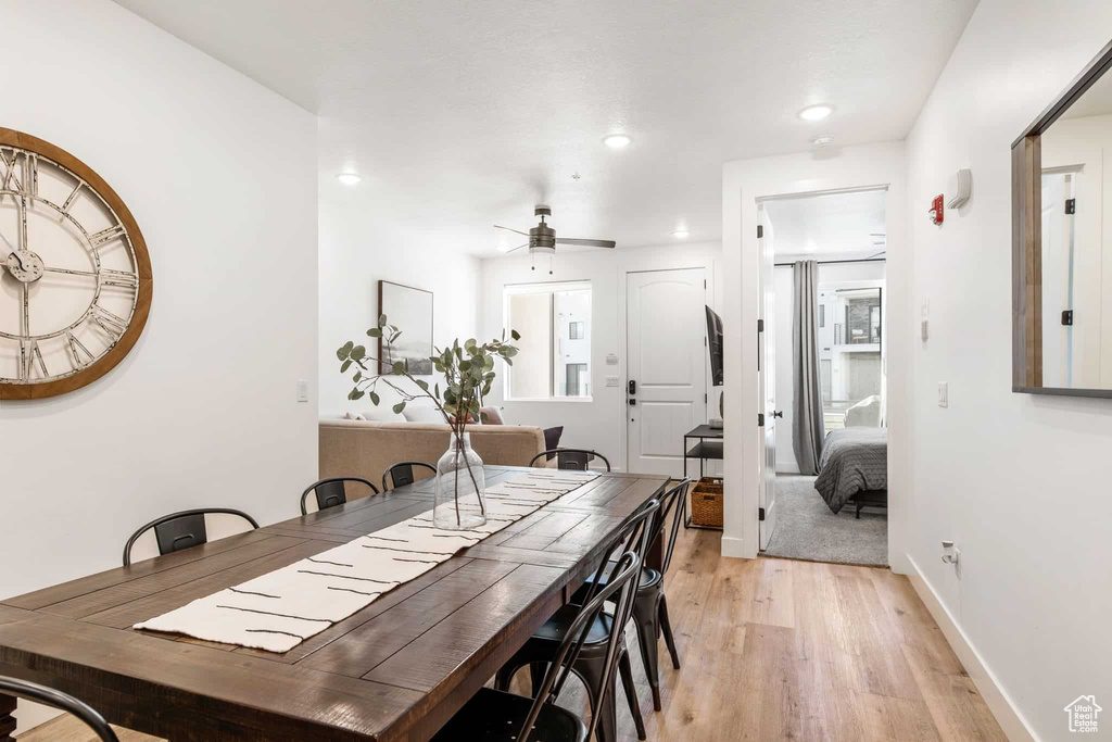 Dining area featuring light wood-style floors, ceiling fan, recessed lighting, and baseboards