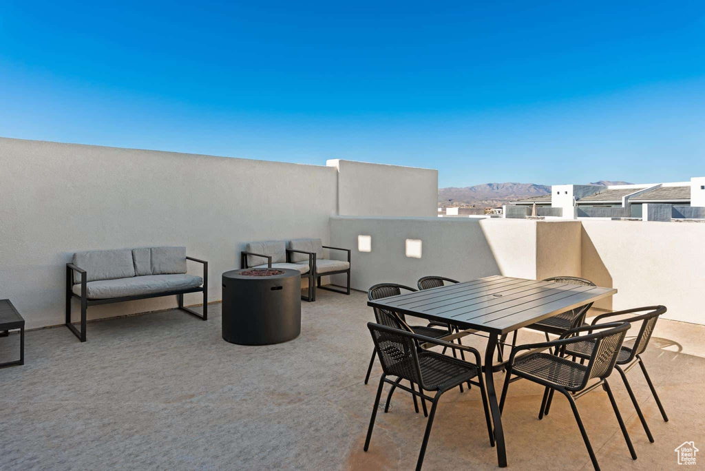 View of patio / terrace featuring a mountain view, a fire pit, and outdoor dining area