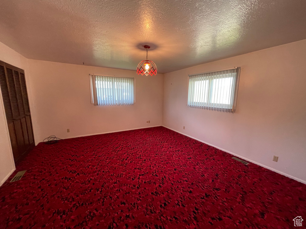 Unfurnished bedroom with carpet and a textured ceiling