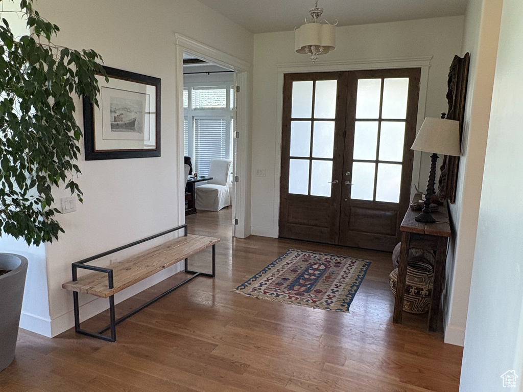 Entrance foyer with wood finished floors, french doors, beamed ceiling, and baseboards
