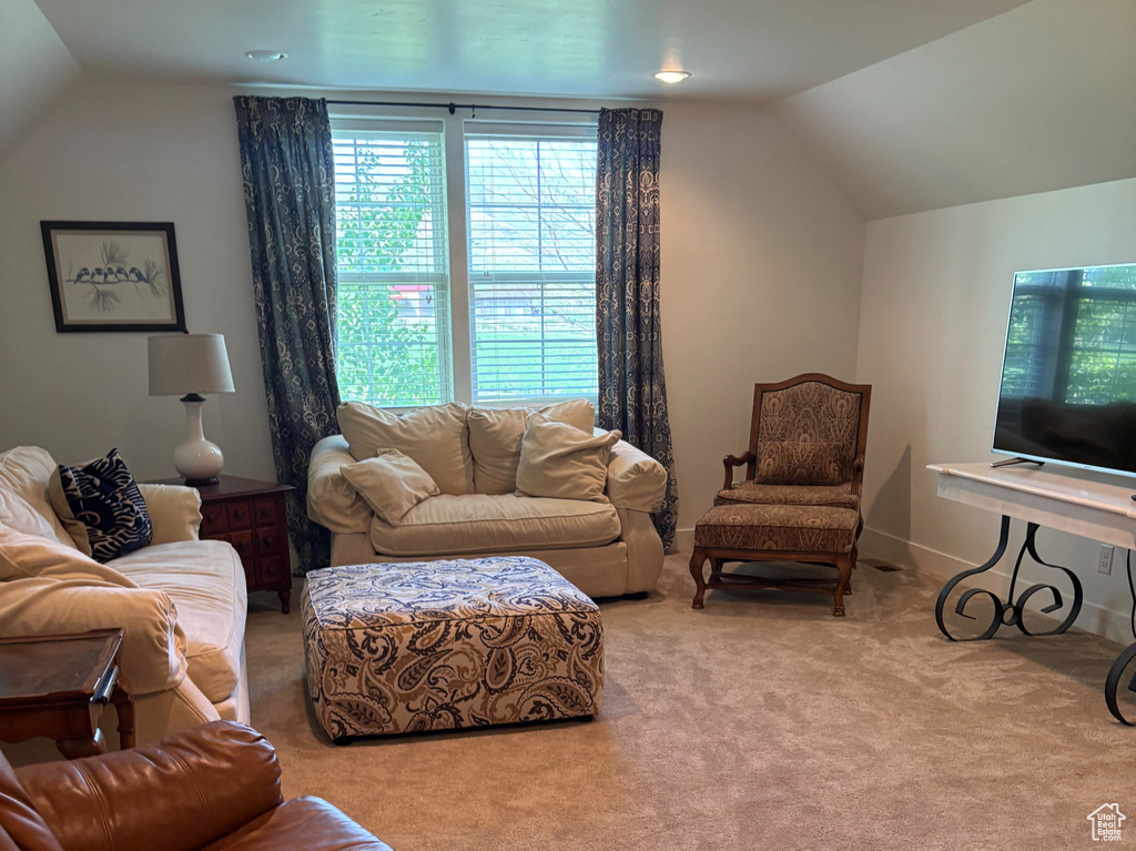 Living room featuring lofted ceiling and carpet floors