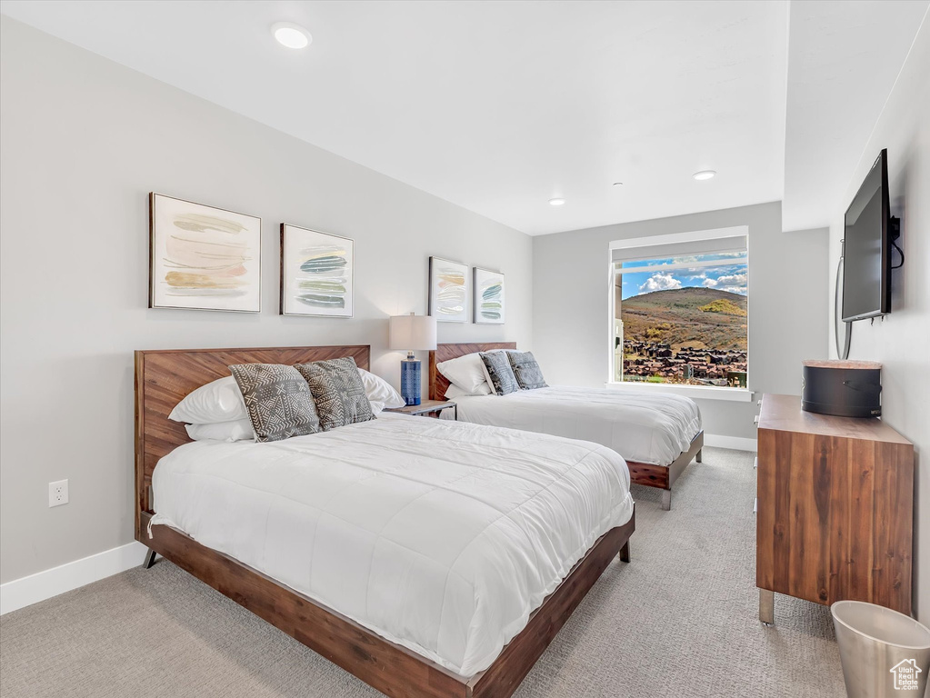 Bedroom featuring light carpet, baseboards, and recessed lighting