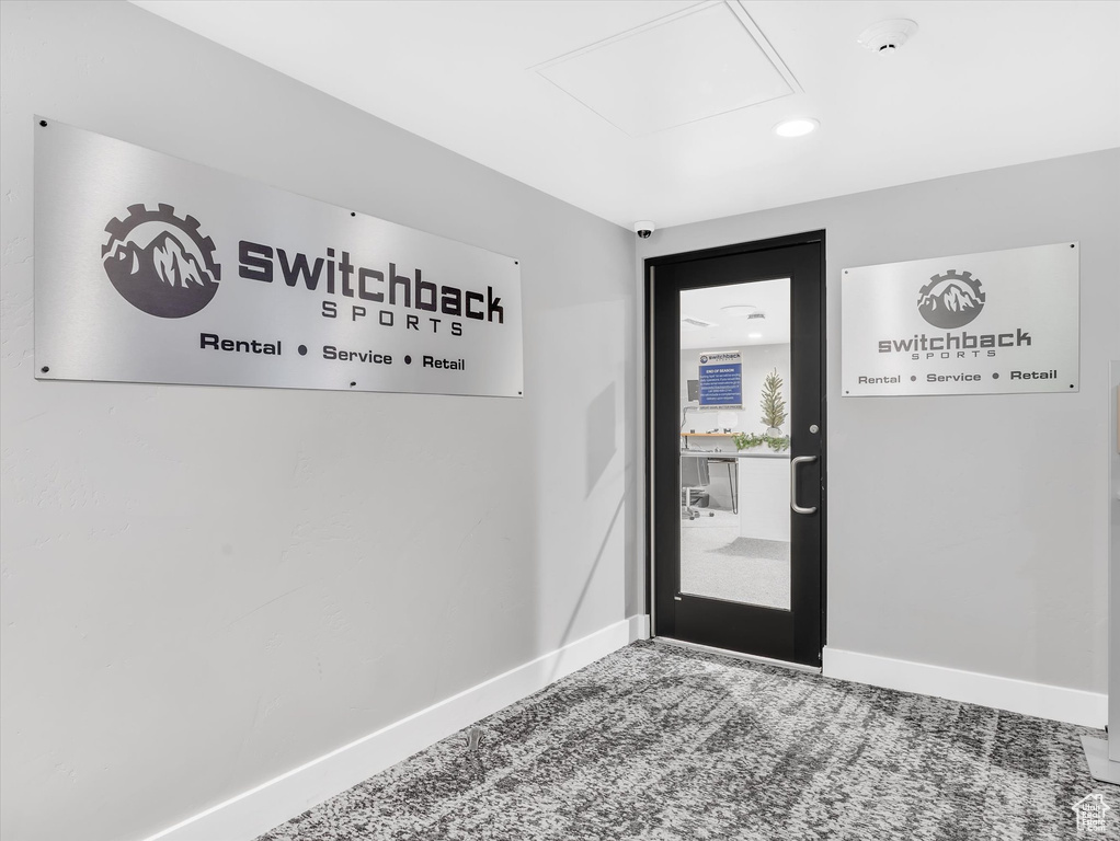 Doorway to outside with baseboards, carpet, and recessed lighting