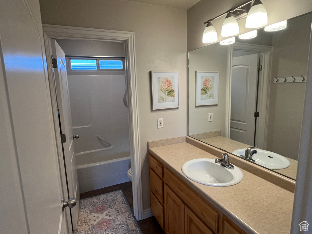 Bathroom with vanity, toilet, and bathtub / shower combination