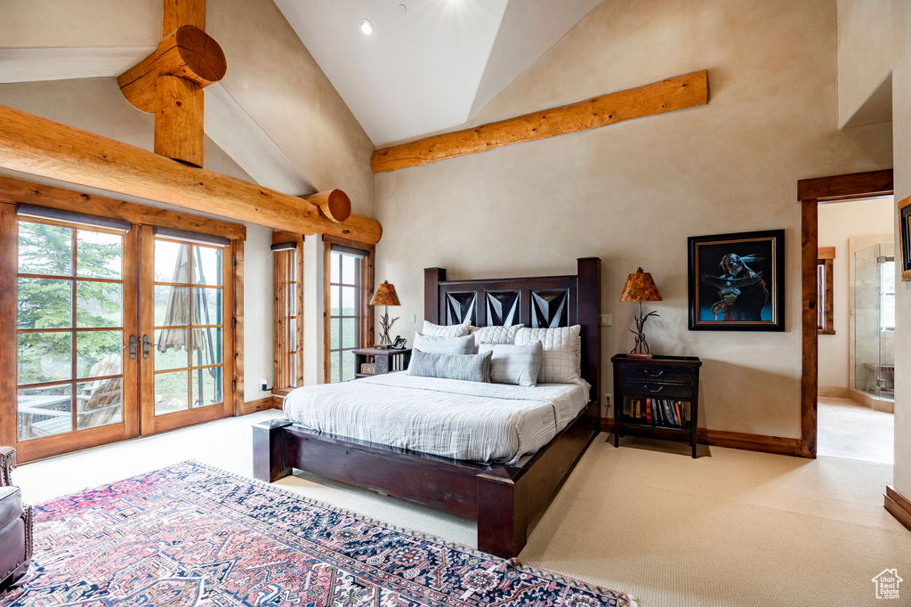Carpeted bedroom with french doors, high vaulted ceiling, access to outside, and baseboards