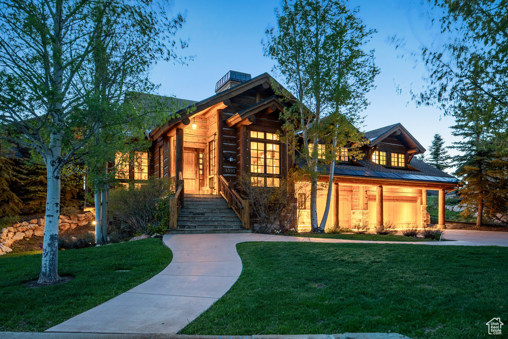 Log cabin featuring a yard