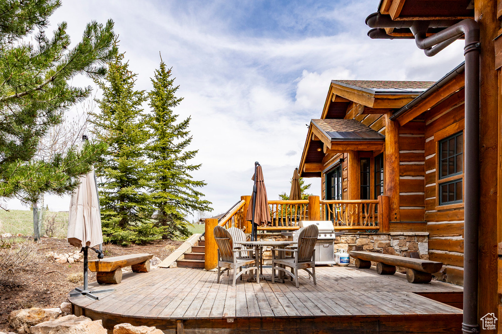 Wooden terrace featuring outdoor dining area
