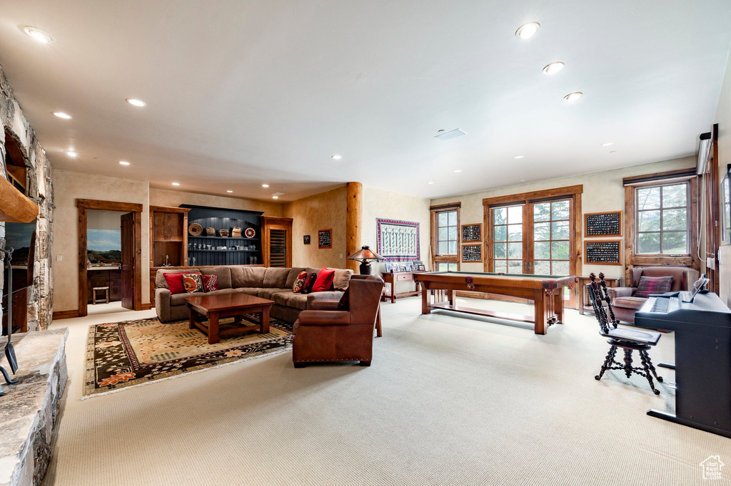Living room with carpet floors, recessed lighting, billiards table, and a fireplace