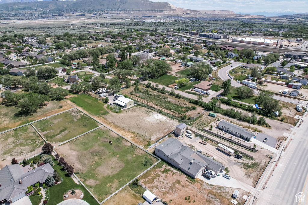 Aerial view of property and surrounding area with a mountain backdrop