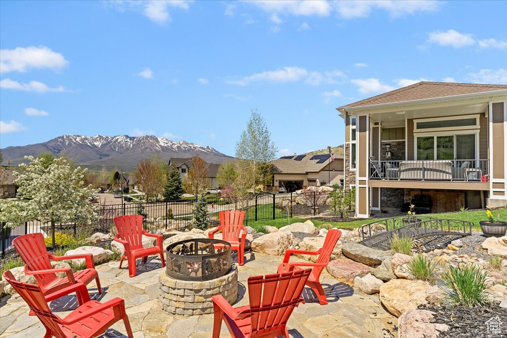 View of patio / terrace featuring a fire pit, a fenced backyard, and a mountain view