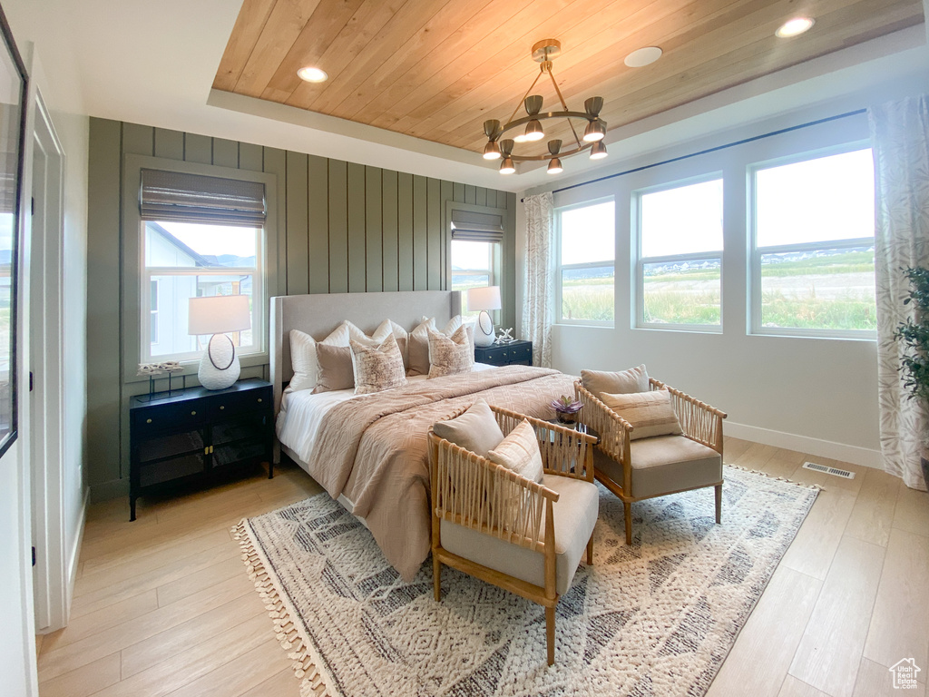 Bedroom featuring multiple windows, a chandelier, recessed lighting, light wood-style flooring, and wooden ceiling