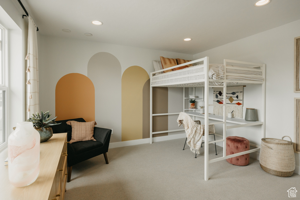 Bedroom with carpet, recessed lighting, and arched walkways