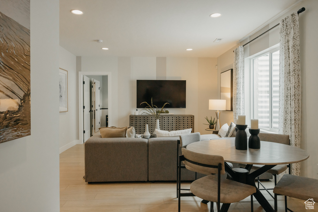 Living area with light wood-style floors, recessed lighting, and baseboards