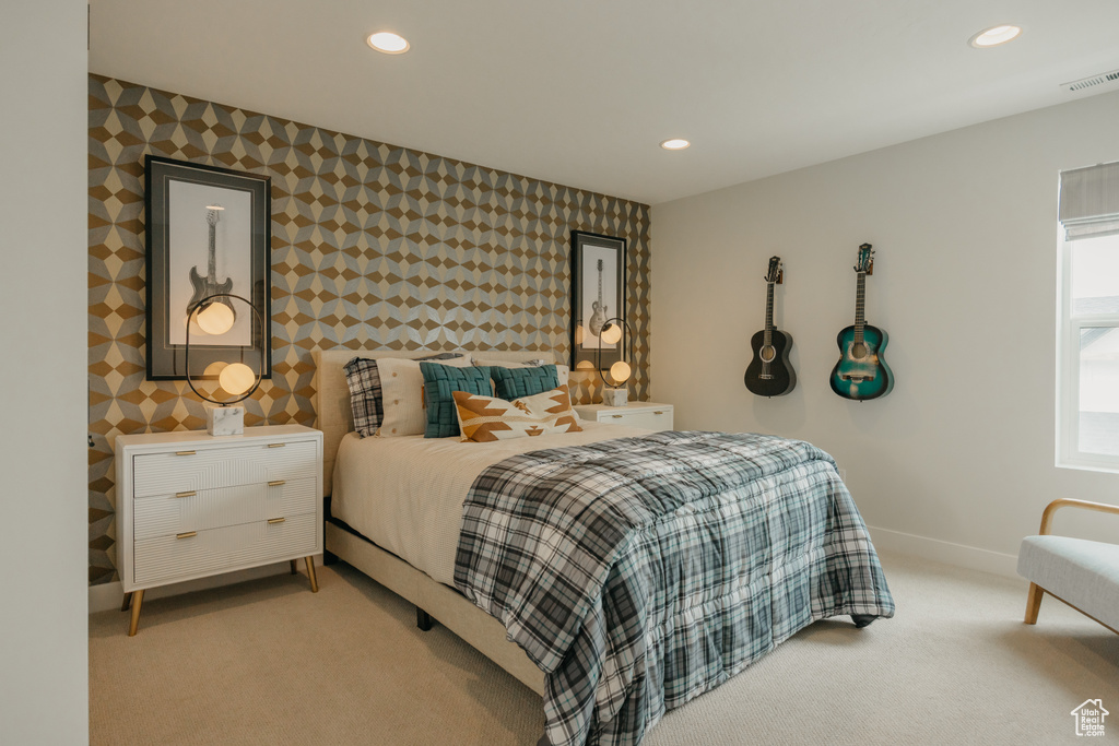 Bedroom featuring wallpapered walls, light colored carpet, baseboards, and recessed lighting