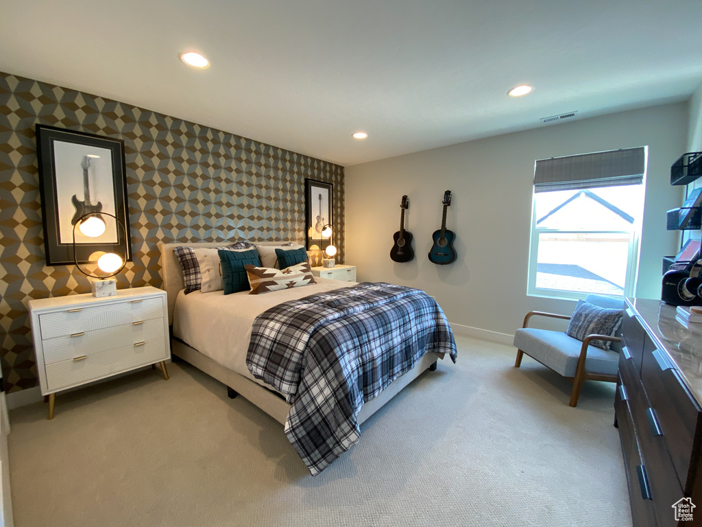Bedroom featuring baseboards, wallpapered walls, light colored carpet, and recessed lighting