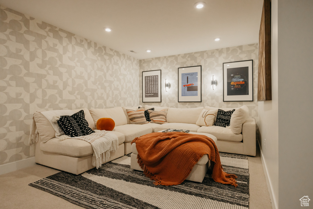 Carpeted living room featuring wallpapered walls, baseboards, and recessed lighting
