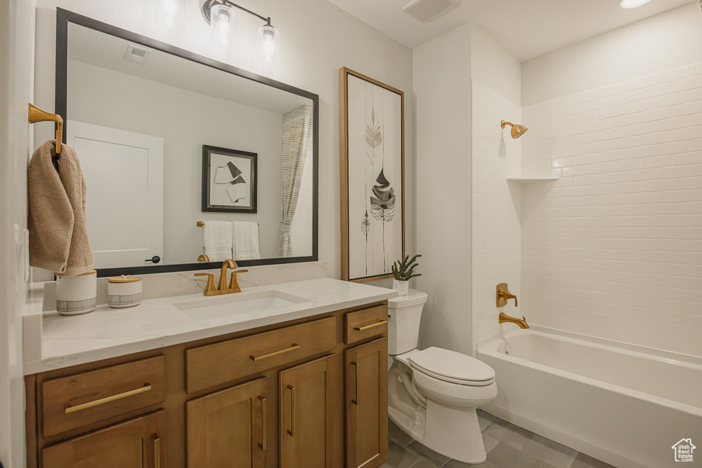 Full bathroom featuring toilet, vanity, bathing tub / shower combination, and tile patterned floors