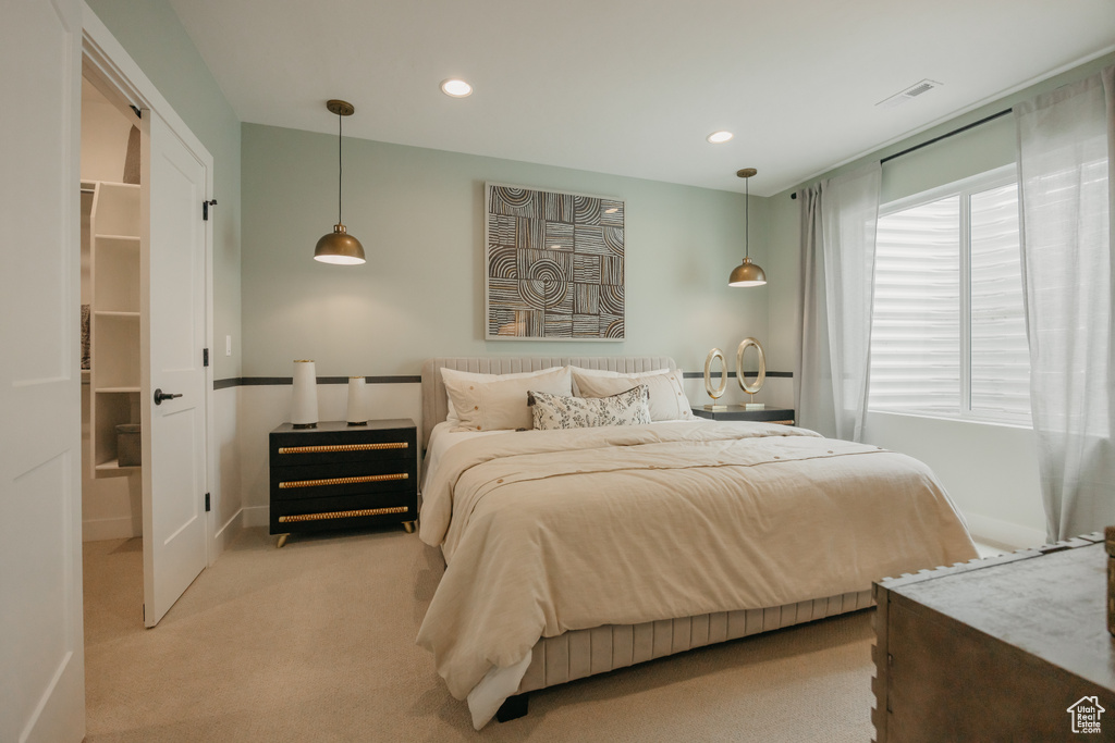 Bedroom with light colored carpet, recessed lighting, and baseboards