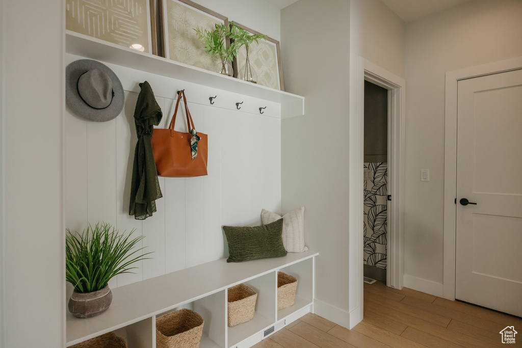 Mudroom with wood finished floors and baseboards
