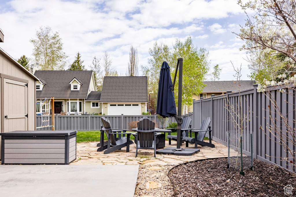 View of patio / terrace with a fenced backyard and a fire pit
