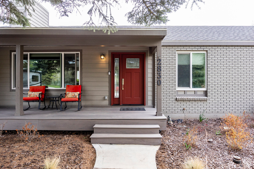 Property entrance featuring brick siding