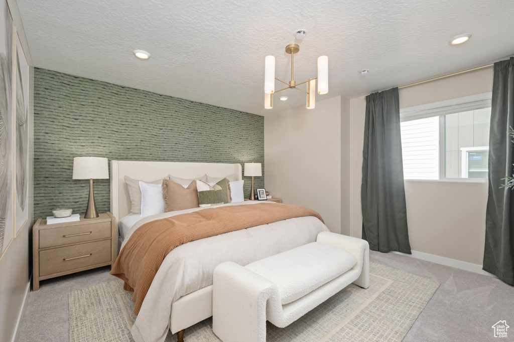 Bedroom featuring light carpet, baseboards, a chandelier, and recessed lighting