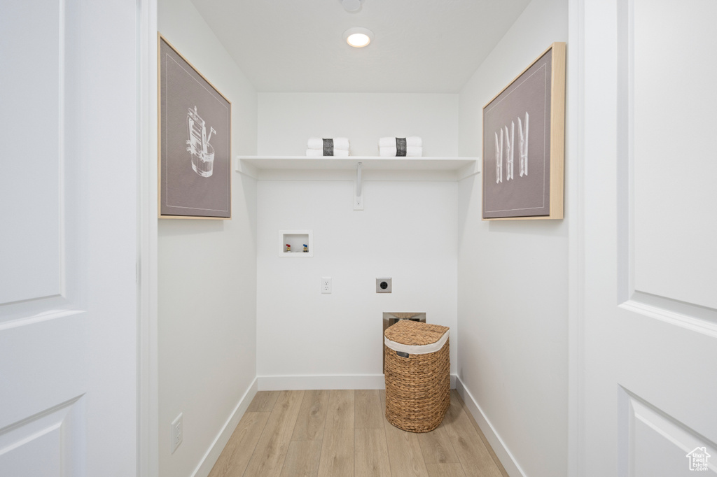 Clothes washing area featuring hookup for a washing machine, light wood-style floors, hookup for an electric dryer, baseboards, and recessed lighting