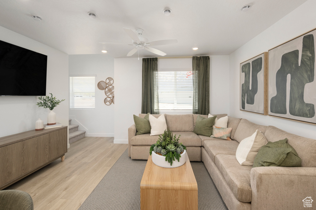 Living area with light wood-style flooring, ceiling fan, recessed lighting, and baseboards