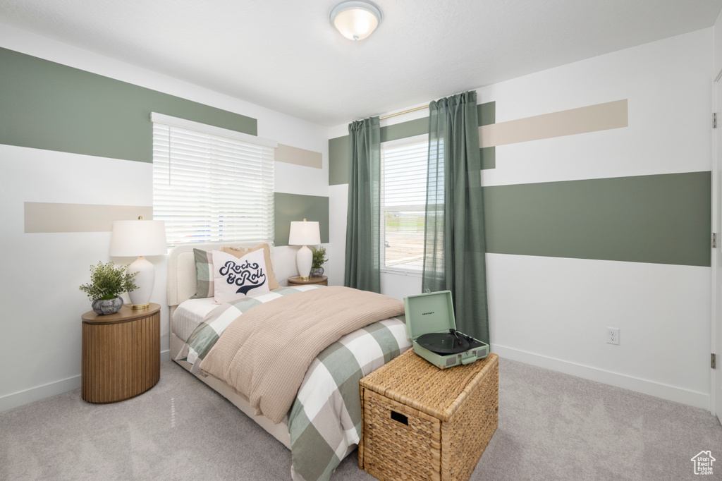Carpeted bedroom featuring baseboards