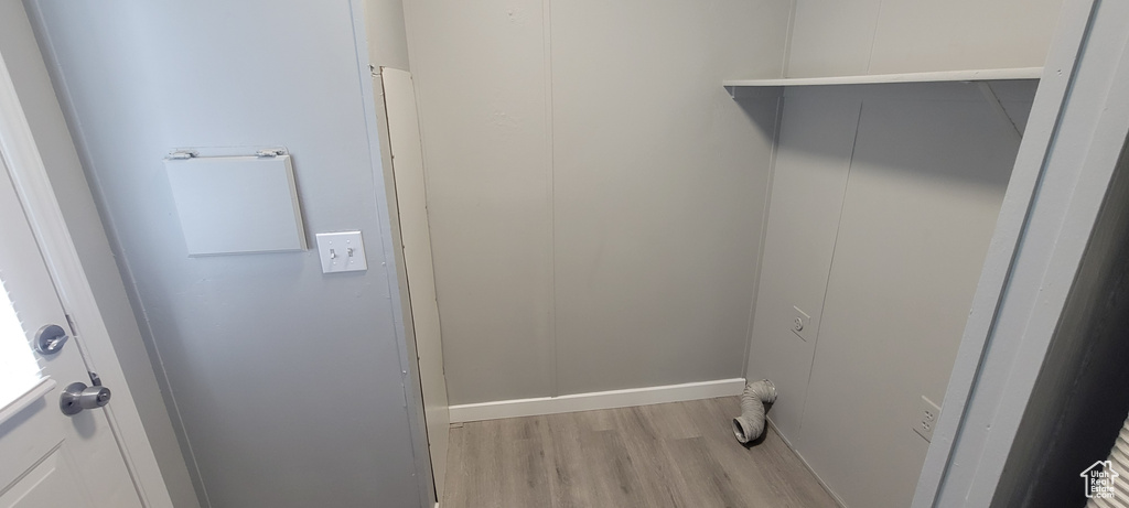 Clothes washing area featuring laundry area and light wood-style flooring