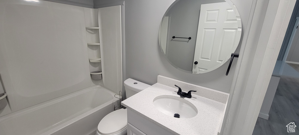 Full bathroom with toilet, vanity, and tub / shower combination
