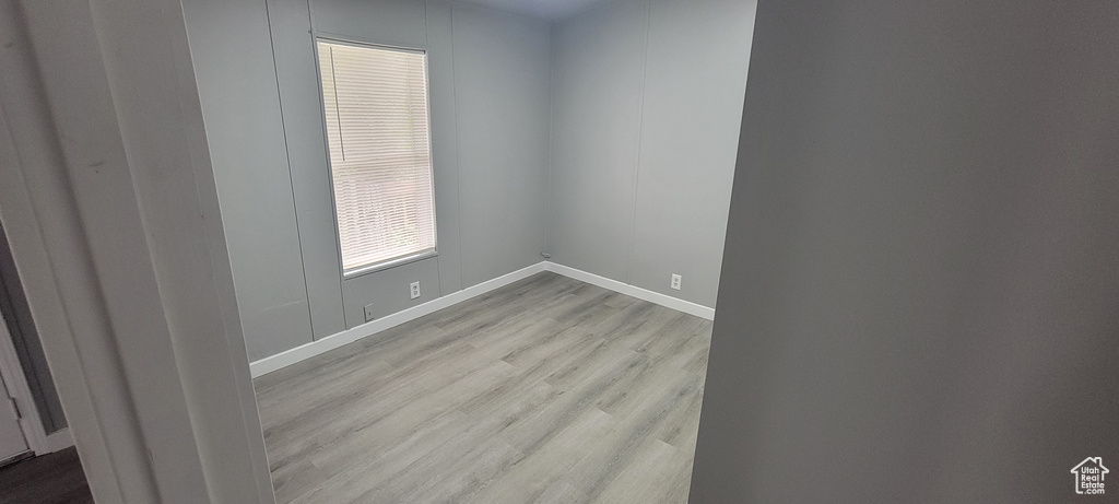 Unfurnished room featuring baseboards and wood finished floors