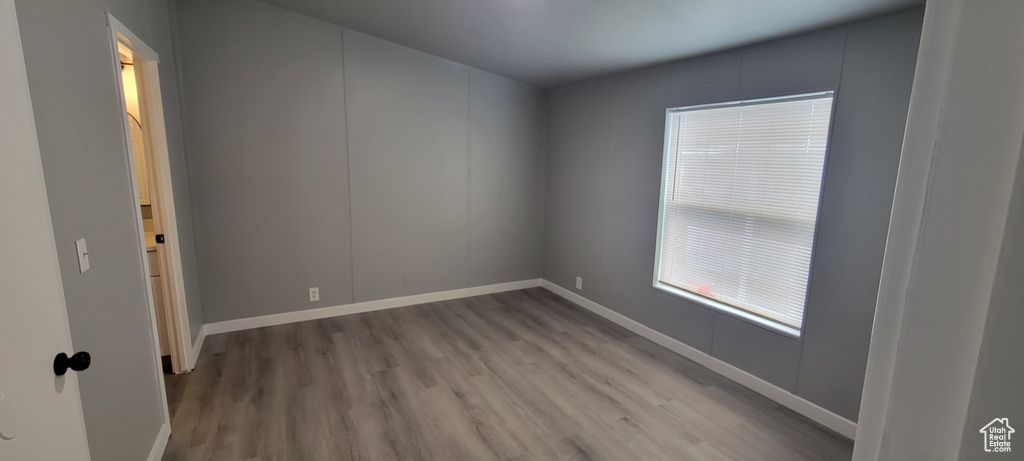 Spare room featuring baseboards and wood finished floors
