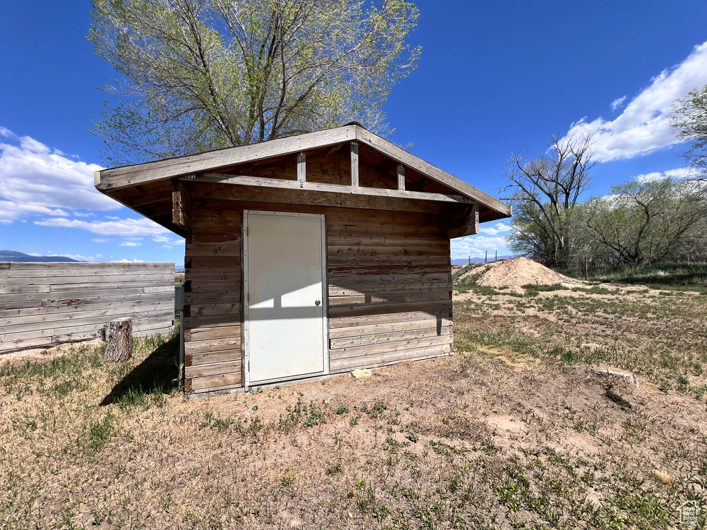 View of shed featuring fence