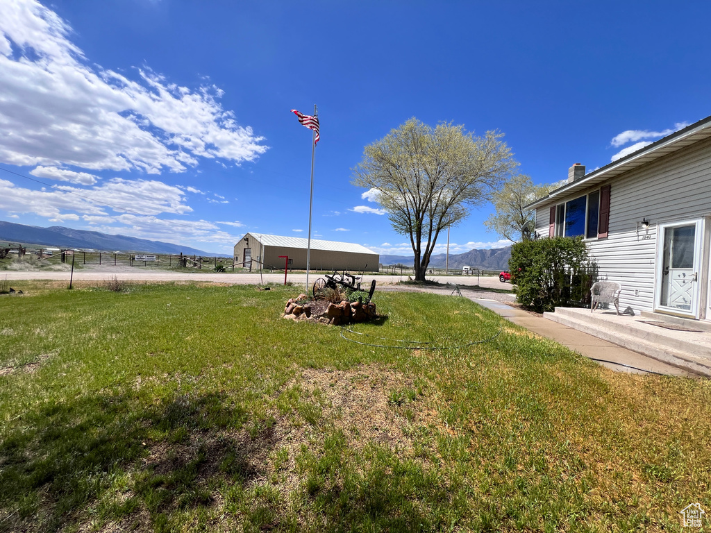 View of grassy yard featuring a mountain view