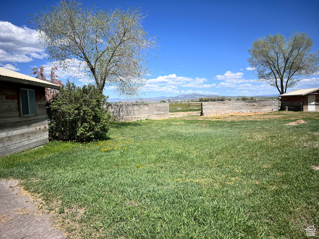 View of grassy yard with a mountain view