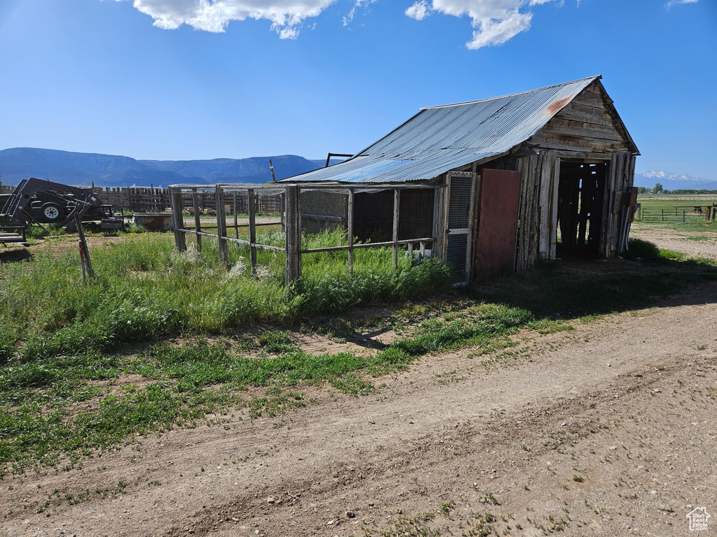 View of poultry coop with fence and a mountain view