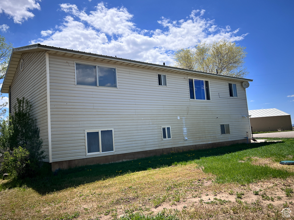 View of side of property with a yard