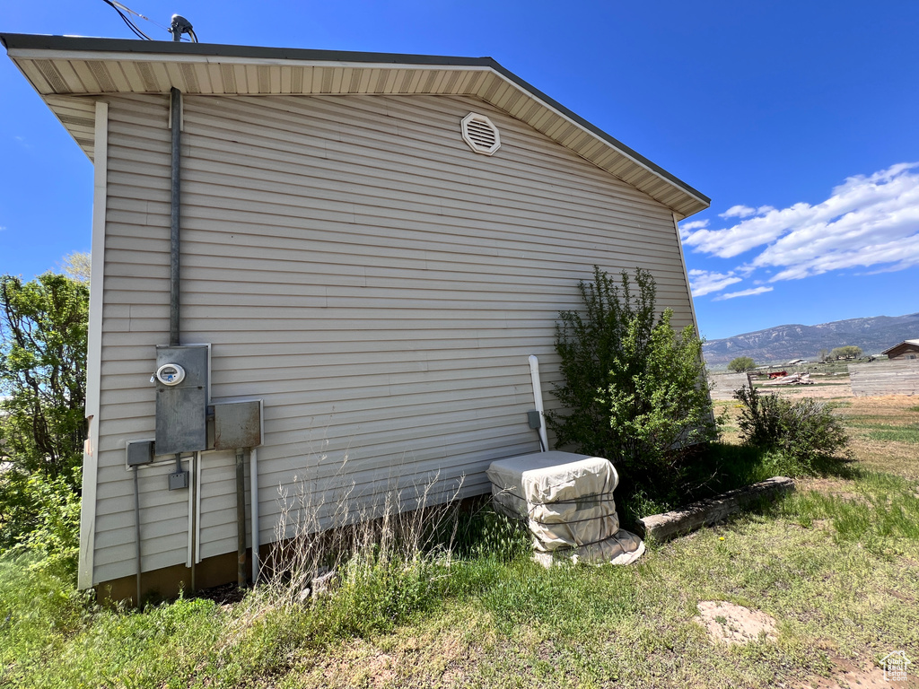 View of property exterior featuring a mountain view