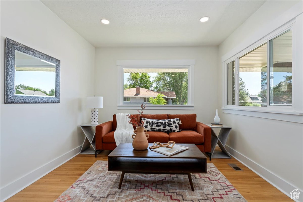 Sitting room with baseboards, recessed lighting, and light wood finished floors