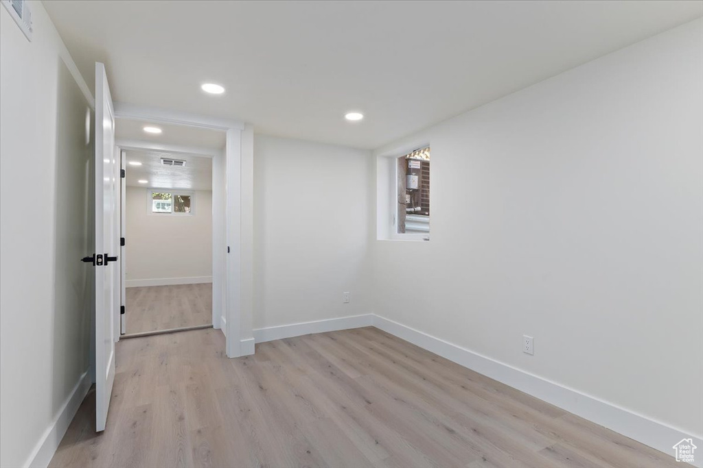 Below grade area with recessed lighting, light wood-type flooring, and baseboards