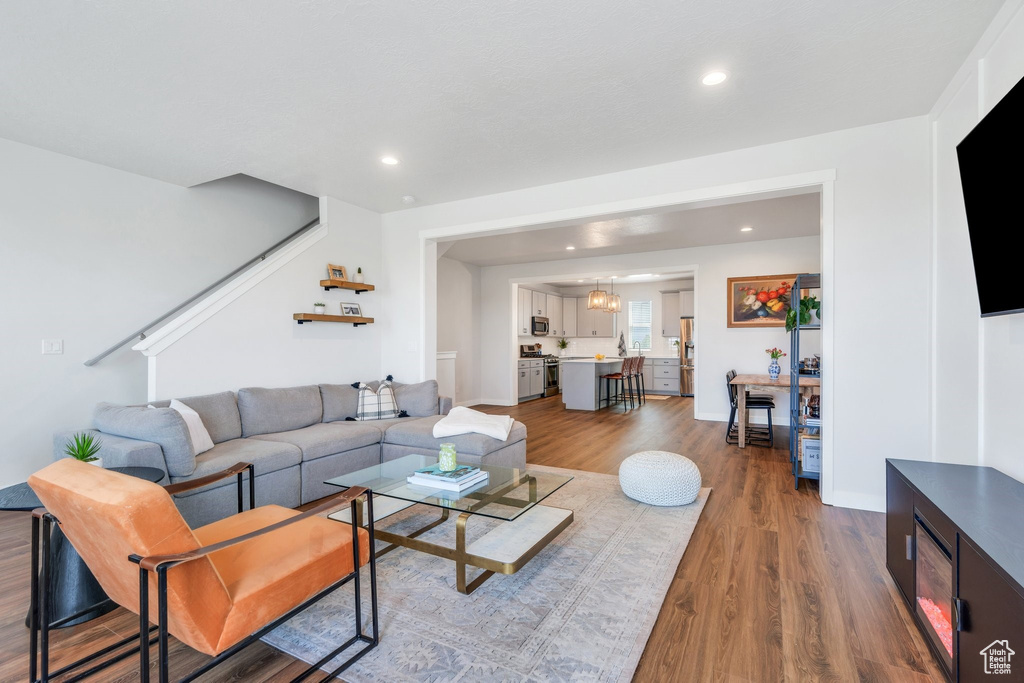 Living room featuring wood finished floors, recessed lighting, and baseboards